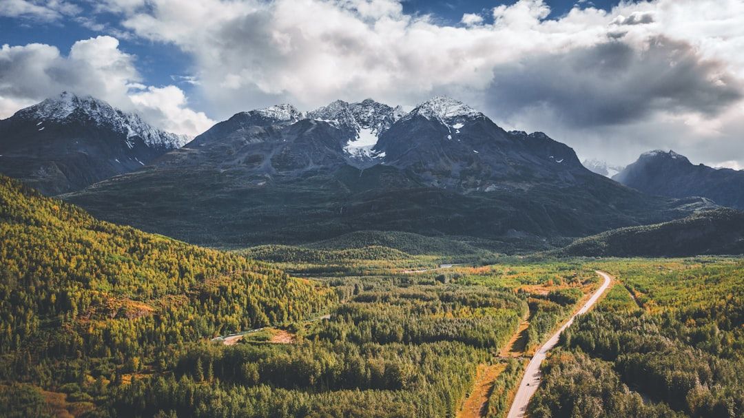 drone view of mountain range above a highway