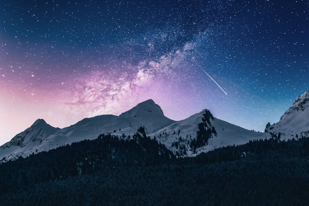 A dramatic mountain landscape bathed in golden sunrise light